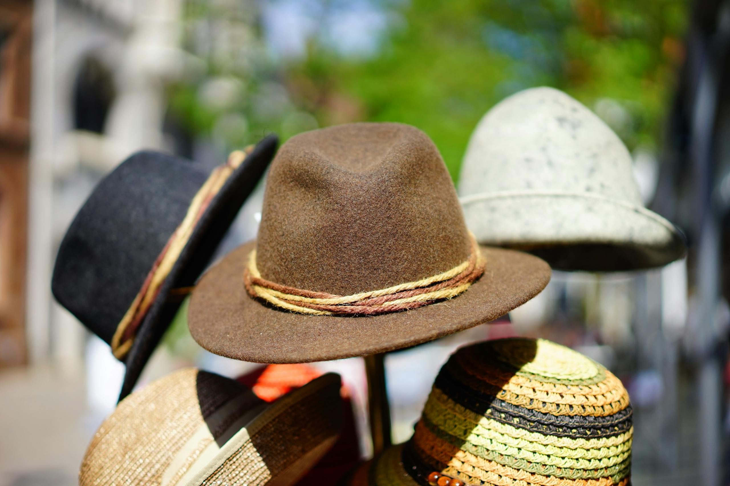 a vibrant display of fashionable fedoras stacked outdoors. perfect for sun protection and style. 35185 scaled
